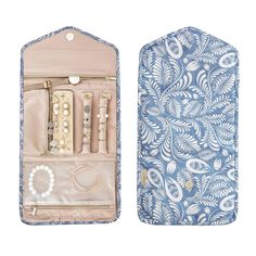 an open blue and white case with jewelry in it's side, on a white background