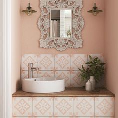 a white sink sitting under a bathroom mirror next to a wall mounted faucet