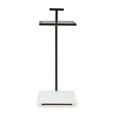 a white scale with a black cross on the top and two shelves above it for storage