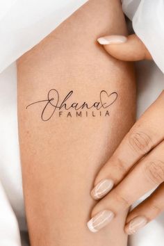 a woman's arm with the word chaos written on it and her name in cursive writing