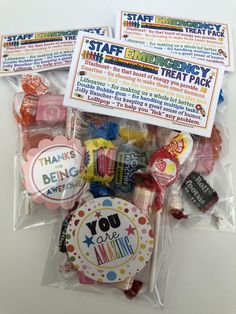 some kind of candy in a bag on a white table with thank you stickers