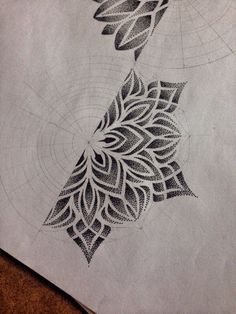 an intricate design is shown on top of a piece of paper that has been drawn