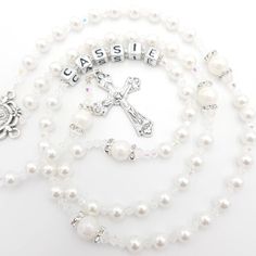 Elegant and personalised Rosary beads made with white pearl beads. Beautiful gift for many occasions such as a christening, first holy communion, baptism, confirmation and much more! Add a name and/or Saint pendant to personalise and choose your own centrepiece with a wide variety available. Please select the colour of the Hail Mary beads from drop down menu then choose the centrepiece you would like as numbered in photos. Made with -6mm white pearl beads (Hail Mary) -8mm white pearl beads (Our White Pearl Rosary As A Gift, White Pearl Rosary As Gift, Personalized White Jewelry For Baptism, Beaded Rosary For Baptism, Pearl White Rosary For First Communion, Elegant White Rosary For Baptism, White Pearl Rosary For Baptism, Adjustable White Rosary For First Communion, Personalized White Jewelry For First Communion