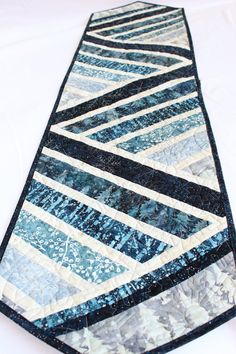 a blue and white quilted tie laying on top of a table