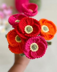 there are crocheted flowers in someone's hand