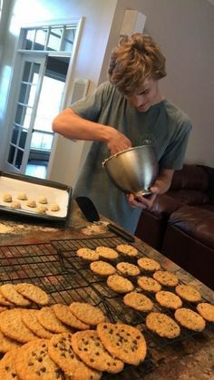 a man cooking cookies on top of a grill