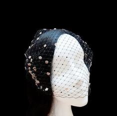 "Elegant black birdcage veil adorned with small gold polka dots of lace and black Swarovski crystal. This accessory is perfect to wear in special events, weddings or a night look. ❈ DETAILS: * Handmade in Andalusia, Spain * Length 34 cm (13.4 in) Width 22 cm (8.7 in) ❈ STANDARD SHIPPING is via postal mail with tracking number and signature for delivery. Available Express Shipping in the cart before paying the order. ❈ More Women's Hats & Headpieces: https://www.etsy.com/es/shop/GloandSons?ref=se Elegant Adjustable Veil For Party, Elegant Evening Veil With Headband, Elegant Wedding Veil In Net Material, Elegant Net Wedding Veil, Black Veil Headpiece, Elegant Black Party Veil, Elegant Wedding Veil In Net, Black Veil Hat, Elegant Wedding Veil Made Of Net