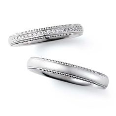 two white gold wedding bands with diamonds on each side, set in 18k white gold