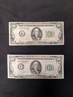 two twenty dollar bills sitting side by side