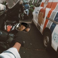 a person is taking a picture in the side mirror of a motorcycle