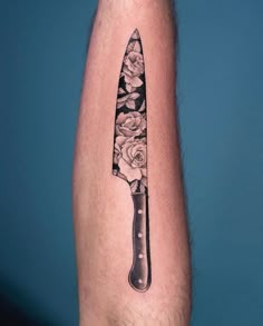 a knife with roses on it sitting on the arm