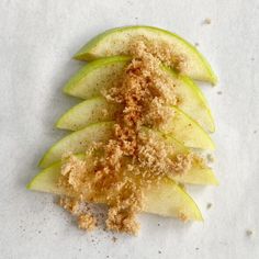 an apple cut in half with some sugar on top