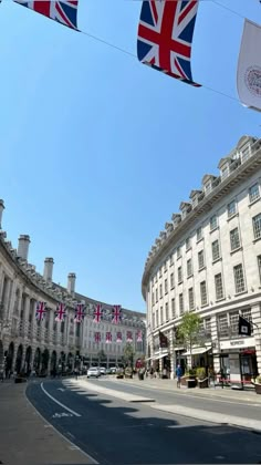 the british flag is flying in front of some buildings