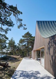 the house is made out of wood and has a curved roof