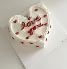 a heart shaped cake with the word love written on it