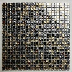 an abstract mosaic tile design with gold and black squares on the side, against a white wall