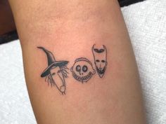 a tattoo with three masks on the arm and one is wearing a witch's hat