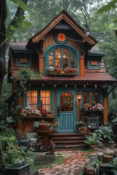 a small house in the woods with lots of plants and potted plants on it