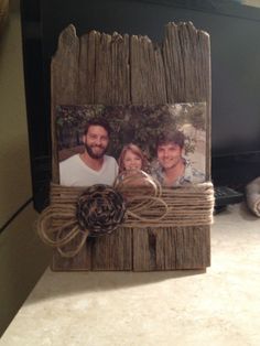 an old photo frame with two people on it