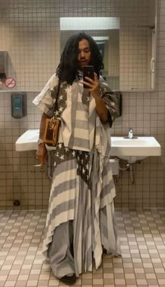 a woman taking a selfie in a bathroom