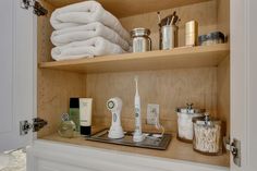 a bathroom shelf filled with lots of personal care items