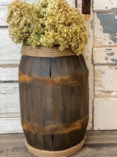 a wooden barrel with some flowers in it