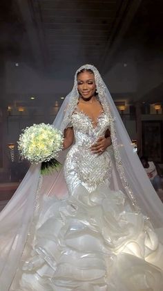 a woman in a wedding dress holding a bouquet