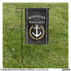 the robinson family beach house garden flag is on display in the grass with an anchor