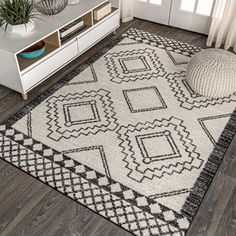 a white rug with black and grey designs on it