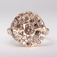 a gold ring with brown and white diamonds