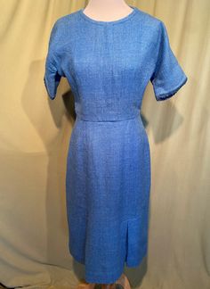 This is a cute vintage dress from the late 40s or early 50s.  Labeled J. Harlan Originals. No size tags. The bust measures 36", waist 26", hip 36", see measurements below.  Made of a heather blue wool. It is not lined. It has short sleeves that are an extension of the bodice & back, not set-on sleeves.  The sleeve edges are trimmed in a slightly darker blue wool yarn loop trim. The neckline is a small circle. The bodice is princess seamed. The skirt is narrow with two inverted pleats at the heml Classic Blue Dress For Vintage Fashion, Blue 1950s Style Knee-length Vintage Dress, Blue Knee-length Vintage Dress 1950s Style, Blue Knee-length 1950s Vintage Dress, Blue Fitted Vintage Dress With Short Sleeves, Blue Fitted Retro Vintage Dress, 1950s Style Knee-length Blue Dress, Blue Knee-length Vintage Dress For Vintage Fashion, Blue Knee-length Dresses In 1950s Style