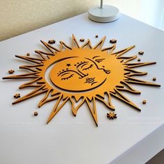 the sun and moon symbol is on top of a white table