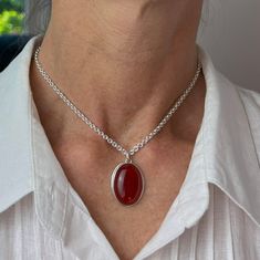 This carnelian pendant is bezel set on a cable chain. And the smooth, polished gemstone in burnished red makes a nice statement wherever you are. It makes a great gift for a friend or family member who likes gemstone pendants in warm colors. Made from nickel-free sterling silver and genuine carnelian. Size:- The pendant length is 1"- The pendant width is 11/16"- The gemstone is 25 x 18 millimeters- The chain length 14”- The chain width is 2.8 millimeters Handmade:This pendant is handmade with a Citrine Jewelry, Carnelian Necklace, Gemstone Pendant Necklace, Gemstone Pendants, Carnelian Pendant, Gemstone Necklace Pendant, 21 Days, Rope Chain, Cable Chain