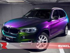 a purple and green bmw suv parked in a parking garage