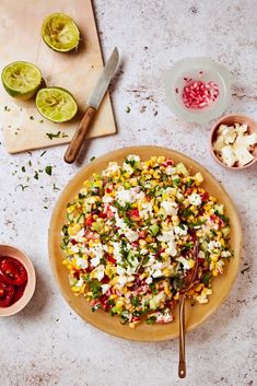 a plate filled with corn and vegetables next to other ingredients