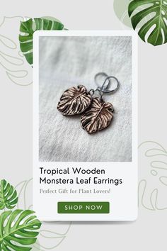 tropical wooden monster leaf earrings on a white background with green leaves around it and the text tropical wooden monster leaf earrings perfect for plant lovers