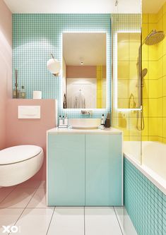 a bathroom with blue and yellow tiles on the walls, white flooring and a bathtub