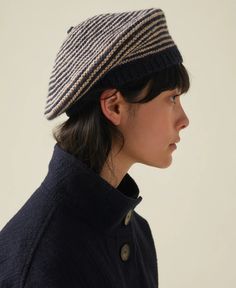 a woman wearing a striped hat and coat