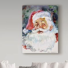 a watercolor painting of santa claus on a wall above a couch with white pillows