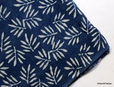 a blue and white cloth with leaves on it