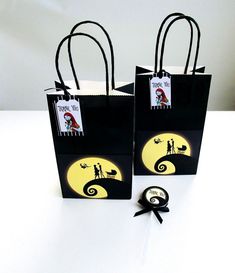 two black bags with yellow and white designs on them