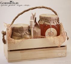 a wooden basket filled with honey and jars