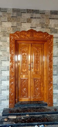 a large wooden door sitting in front of a stone wall