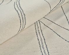 a close up view of a white fabric with black lines on the back and sides