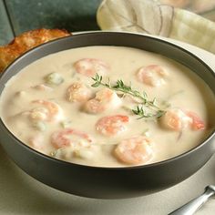 there is a bowl of soup with shrimp in it