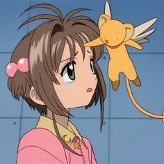 an anime character holding a stuffed animal in front of her face