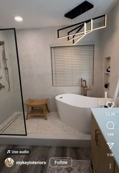 a bathroom with a large white tub sitting next to a walk in shower