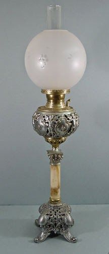 an old fashioned lamp with a white glass ball on it's top and base