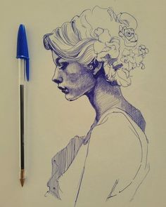 a drawing of a woman's head with flowers in her hair and a pen