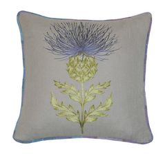 an embroidered pillow with blue and green flowers on it